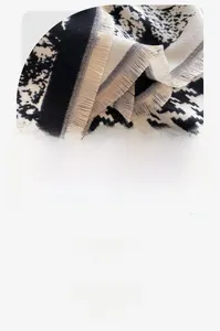 Close-up of classic houndstooth scarf showing high-density yarn and tassel edge details