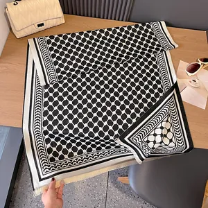 Détail d'une écharpe en cachemire à carreaux noir et blanc avec bords à franges