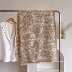 Detail of Toile de Jouy tiger print and houndstooth border on a thick winter scarf