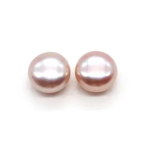 Close-up of a pair of natural pale pink button pearls with smooth metallic luster