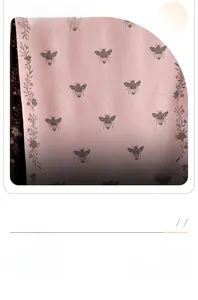 Macro detail of bee embroidery and floral patterns on pink cashmere-like knit scarf