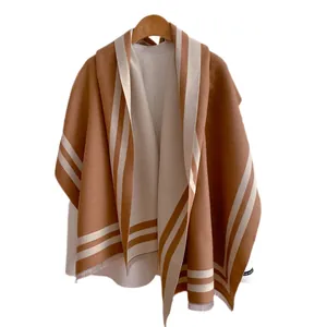 Beige cashmere shawl with horizontal stripes and fringe detail on a wooden hanger