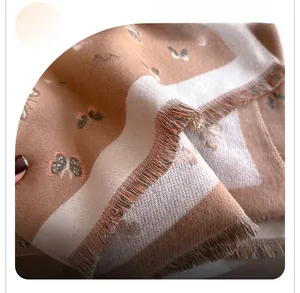 Close-up of the butterfly pattern and fine tassel edge on a soft winter pashmina shawl