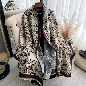 Ethnic knit shawl with geometric floral pattern and fringe in blue and brown