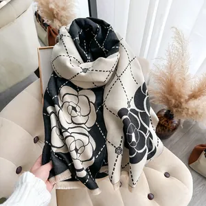 Detailed view of camellia jacquard scarf featuring double-sided patterns and fringed edges