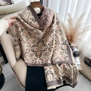 Detailed view of winter cashmere-like scarf with clover floral pattern and soft fringe