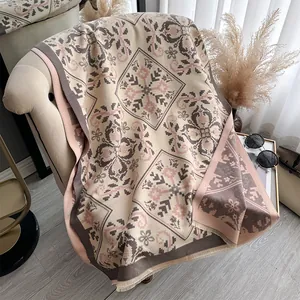 Detail view of ethnic cashmere-feel scarf with geometric patterns and fringe edges