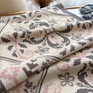 Detail of retro floral knit cashmere-like shawl with intricate geometric patterns