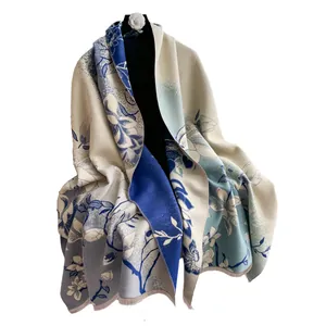 Elegante chal de cachemira jacquard con motivos florales azules y detalles de flecos