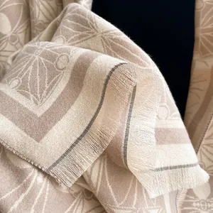 Elegant beige cashmere-feel scarf with geometric floral jacquard and tassel details