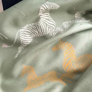 Detail shot of the woven zebra pattern and premium texture of the green knit shawl scarf