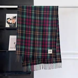Detail of checkered cashmere-feel scarf with fringes and Good Luck woven label