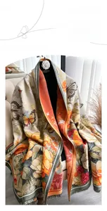 Detailed macro view of the cashmere-like fabric showing floral patterns and fringe edges