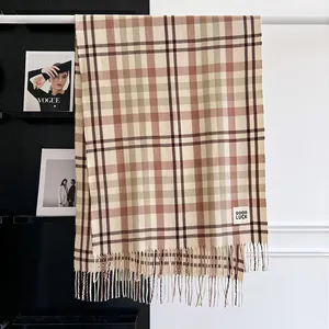 Detailed view of plaid cashmere-like scarf with fringe and Good Luck label