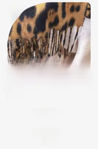 Detail of leopard print scarf showing high-density fabric texture and fringe tassels