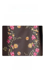 Detailed view of floral embroidery with colorful silk threads on warm thick scarf
