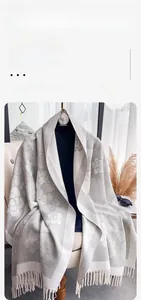Detailed view of the camellia pattern and short fringes on this warm winter scarf