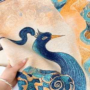 Close-up of jacquard woven cashmere feel shawl featuring blue and yellow phoenix patterns