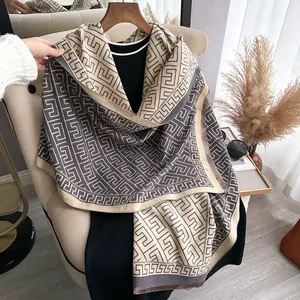 Close-up of geometric pattern cashmere-feel scarf with elegant fringe detail