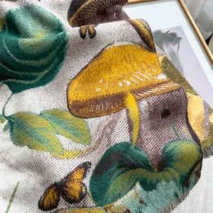 Detailed texture of butterfly and mushroom jacquard pattern with fringe trim on shawl