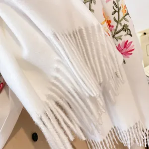 Thick warm white pashmina shawl with floral embroidery and tassel fringe details