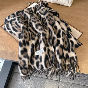 Detailed macro view of 100% cashmere leopard print scarf with soft fringe edges