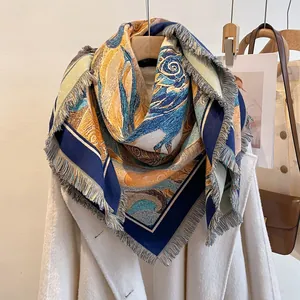 Close-up of artistic oil painting print scarf with fringe hanging on a white coat