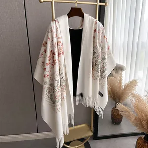 Off-white cashmere-feel shawl with ethnic floral embroidery and tassel details