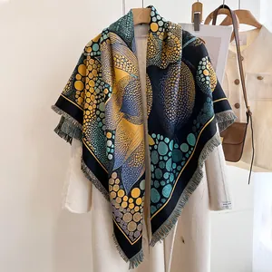 Close-up of color-block reversible cashmere scarf with floral patterns and frayed edges