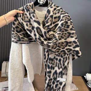 Leopard print 100% cashmere scarf with fringe on a beige sweater, stylish winter accessory