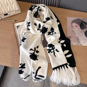 Thick knit winter scarf with black and white rose floral patterns and fringe tassels