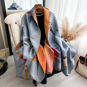 Thick butterfly cashmere pashmina with bird print and fringes in light blue and orange