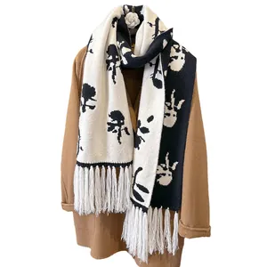 Winter knitted scarf for women with black and white floral jacquard and stylish fringes