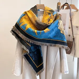 Detailed close-up of Van Gogh sunflower print pashmina shawl with fringe over white coat