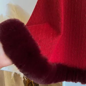 Detailed macro view of red knit fabric with diamond patterns and plush faux fur collar edge