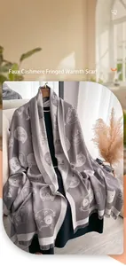 Detailed view of grey pashmina scarf with cute white cat prints and fringe edges