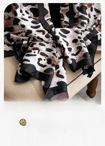 Detail of leopard print silk scarf with high-quality machine-stitched black edges
