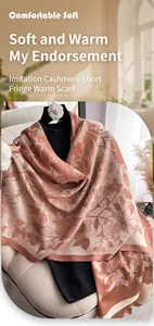 Detail of pashmina-style scarf with vintage floral patterns and fringe on a sofa