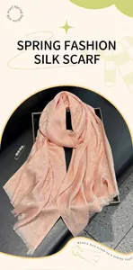 Detail of pink silk-like scarf featuring an elegant monogram pattern and satin finish