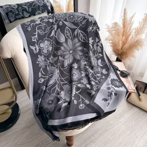 Detail of floral pattern on dual-sided cotton scarf with elegant fringe trim finish