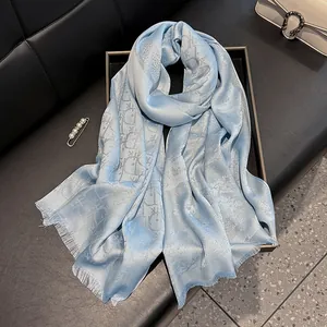 Detail of light blue silk scarf with classic oblique pattern and fine tassel edges