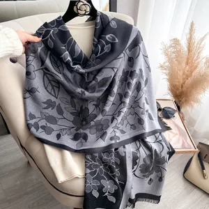 Close-up of floral pattern and fringe edge on a gray and black Tencel cotton shawl