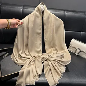 Detail of champagne gold silk shawl with shimmer dot jacquard and fringe edges