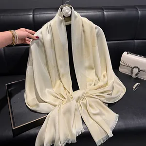 Elegant cream silk scarf with gold geometric print and frayed edges for women