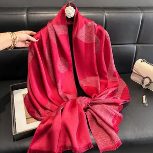 Detail view of red silk shawl with silver glitter threads and abstract circular patterns