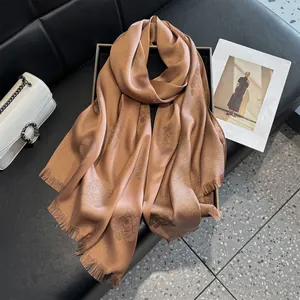 Detailed view of champagne camellia jacquard scarf with glitter finish and fringe edge