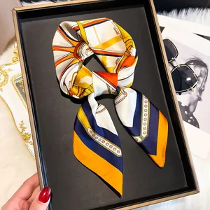 Close-up of luxury silk scarf with equestrian patterns and smooth satin finish texture