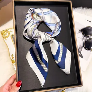 Detail of silk-feel square scarf with chain patterns in a black gift box setup