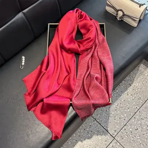 Detail of red silk cotton scarf featuring sparkling silver glitter and fringe edges