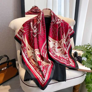 Detail of red and black silk-like square scarf with baroque patterns on a mannequin